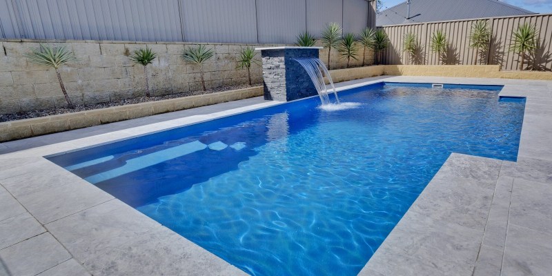Compass Pools Vogue swimming pool shape with a water wall feature